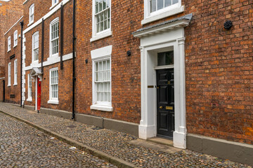 red brick buildings with colorful doors in typical English fashion in the historic city center of Chester