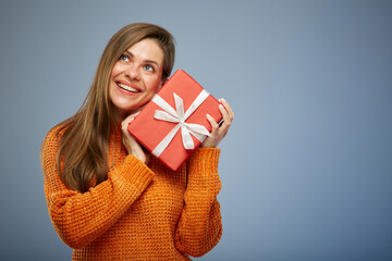 Portrait happy woman with present gift box looking up. isolated on blue background.