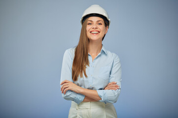 Woman architect or engineer in safety helmet standing with arms crossed. Isolated female portrait.
