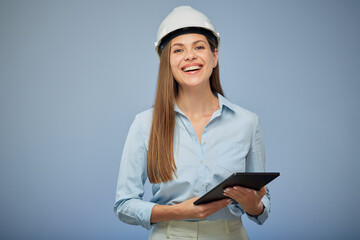 Smiling woman engineer in safety helmet holding tablet. Isolated female portrait.