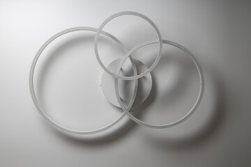 Chandelier in the form of three rings against a white ceiling