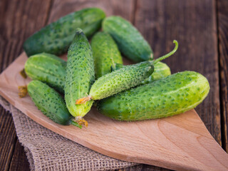Cucumber on dark wood table texture background. Cucumbers for salads or canning. summer vegetables. Organic farming in the village.