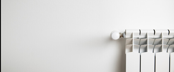 White heater on a white wall. Heating and heat concept. Banner