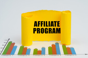 Against the background of the graphs, a yellow paper plate with the inscription - AFFILIATE PROGRAM