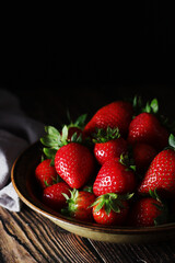 A bowl with ripe bright strawberry in rustic style	