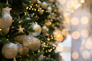 Decoration with a green Christmas tree branch decorated with a golden ball and a star. Sparkling...