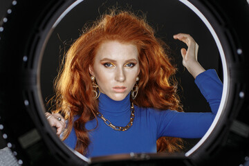 red-haired girl in blue clothes with bright make-up