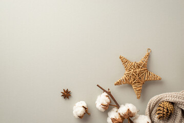 Winter holidays concept. Top view photo of wicker star ornament knitted scarf anise pine cone and cotton branch on isolated pastel grey background with copyspace