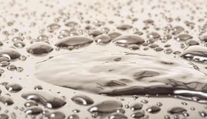 Macro water drops, macro photo of water drops on a reflective surface, selective focus.