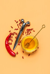Naklejka premium Skincare beauty roller with honey, chili pepper, and goji berries for natural cosmetic ingredients
