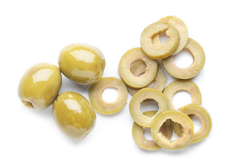 Whole and cut green olives on white background
