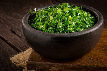 Bowl with chopped green cabbage sautéed in olive oil and garlic.