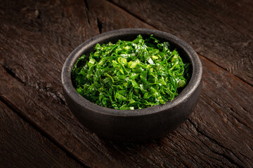 Obraz na płótnie Canvas Bowl with chopped green cabbage sautéed in olive oil and garlic.