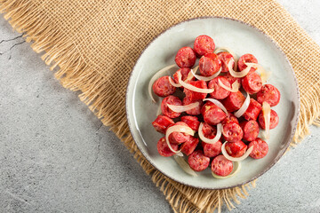 Portion of sausage with onion.