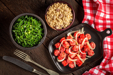 Sliced sausage with onion, green cabbage and farofa.
