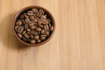 coffee beans isolated in a cup close up,wooden background