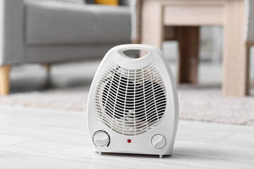 Electric fan heater on floor in living room