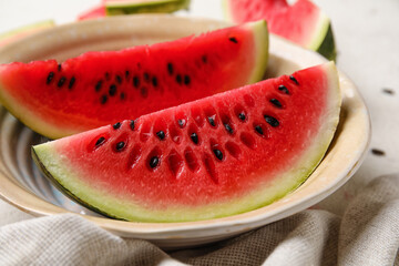 Plate with slices of watermelon and napkin on white background, closeup