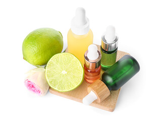 Bottles of citrus serum and limes on white background