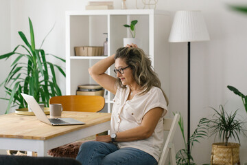 Portrait of adult woman working from home, businesswoman working at home office  