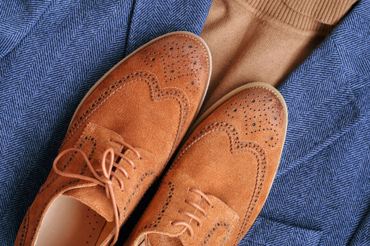  Top view brown suede derby shoes with blue tweed blazer and beige sweater. Casual men autumn outlook.