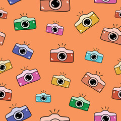 Seamless pattern with hand drawn colorful cameras doodle style, vector illustration on orange background. Bright design for packaging and wrapping, print and web