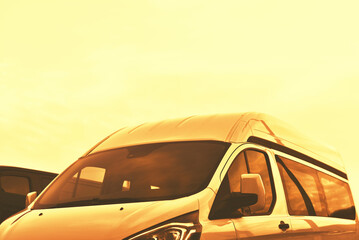 luxury minibus on sky background in gold colors