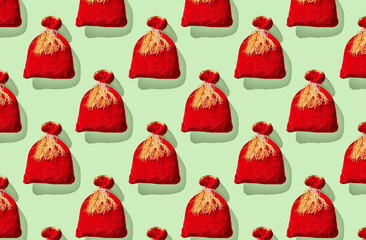 Pattern of red bags on green pastel background