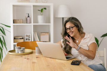 Happy woman having online video meeting from home