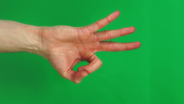 Set of 9 gestures on green screen background made by adult Caucasian man in closeup. A man is showing different signs by his hand and fingers on the chroma key. He is writing and painting in the air