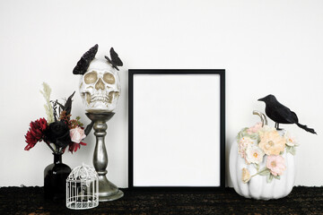 Halloween gothic romance mock up. Black frame on a black shelf with red and black flowers, skull...