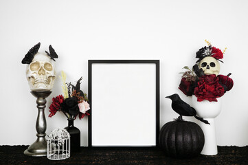 Halloween gothic romance mock up. Black frame on a black shelf with red and black flowers, skulls...