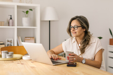 Fototapeta na wymiar Caucasian woman working online from home