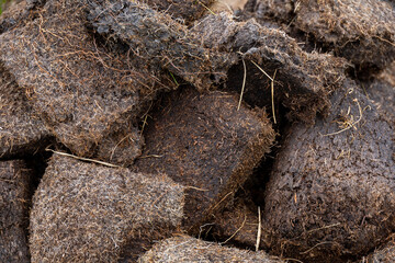 Close up shots of neat peat or turf bricks left to dry outdoors in the summer in a Scottish moor...