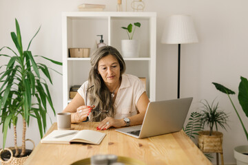 Boomer female freelancer working online from home