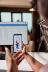 Fototapeta na wymiar Telemedicine, woman having online medical consultation with doctor, focus on smartphone. Patient talking with therapist on video call, general practitioner with stethoscope on mobile phone screen