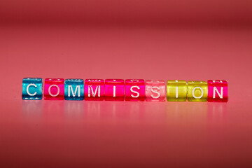 the word "commission" made up of cubes