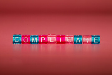 the word "complicate" made up of cubes