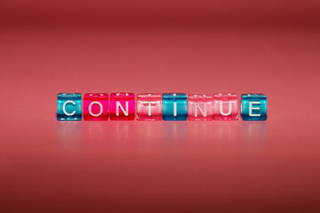 the word "continue" made up of cubes
