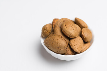 plate with almonds isolated on white