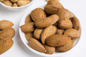 plate with almonds isolated on white