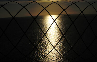 metal structure with abstract seascape in the background