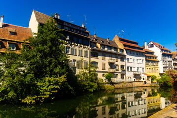 Fototapeta premium Peaceful cityscape of Strasbourg during summertime. Streets and canals of French city.