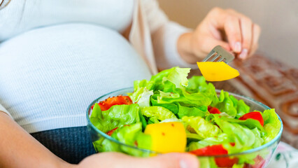 Obraz na płótnie Canvas Pregnant salad healthy food. Pregnancy woman eating nutrition diet food salad. Family nutrition, healthy eating concept.