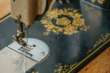 sewing machine with tread and needle in vintage mechanical steampunk machine