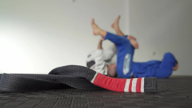 Brazilian jiu jitsu bjj black belt second degree on the tatami mats at gym or academy martial arts concept copy space selective focus