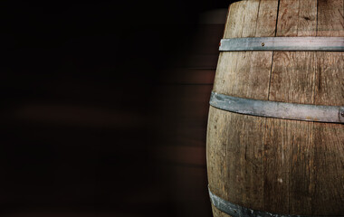 Vintage wooden vine barrel with dark copy space background. concept background. Fragment of an old...