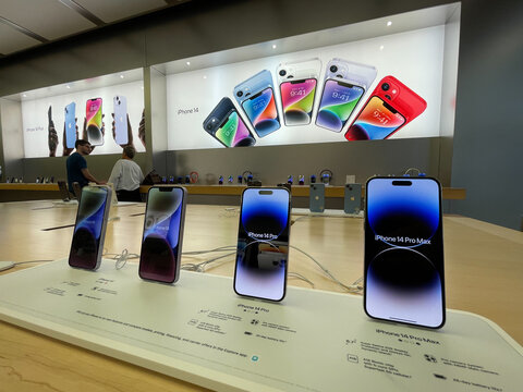 New Jersey, USA - September 21st 2022: A german photographer comparing and testing the new iPhone 14 as well as iPhone 14 Pro models  in an Apple Store.