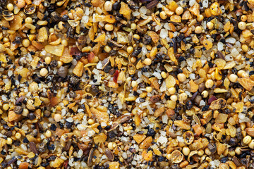A mixture of different spices with salt. Textures of colorful spices and condiments. Spice blend for steak