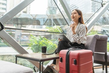 Young asian beautiful female lady making a payment for an online shopping purchase via her smart phone easily and successful while sitting in a cafe